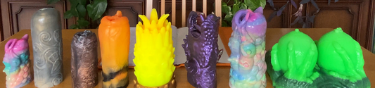 Love Smiths fantasy silicone masturbators in different sizes, colors, and textures displayed together on a wooden table.