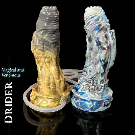 Drider fantasy ooze dildo by Love Smiths – gold and blue colour variants with attached tube and syringe.