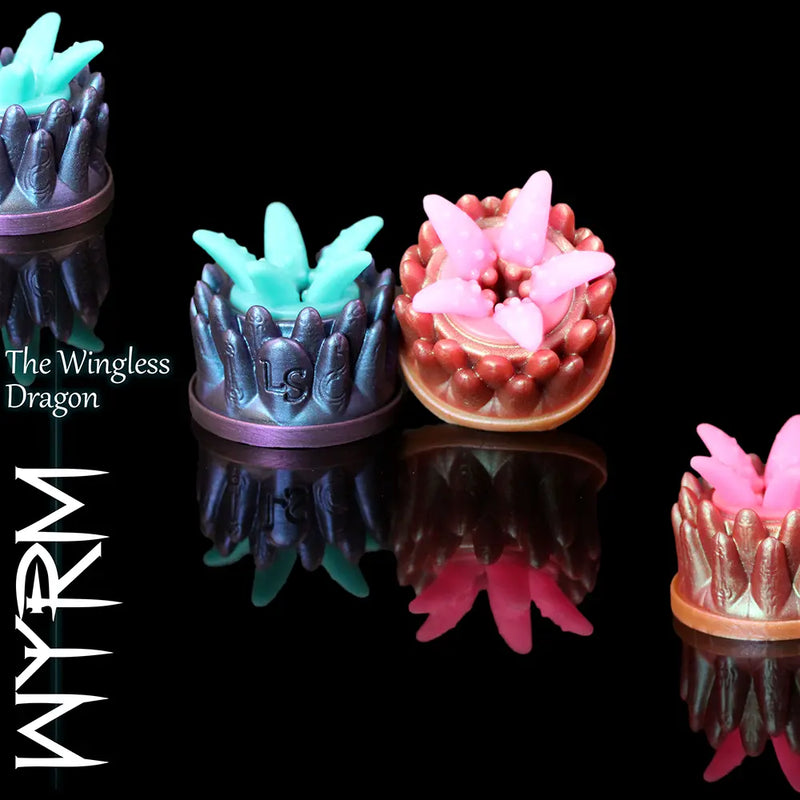 Fantasy Grinder Wyrm silicone grinders in Heroic and Legendary colours on black reflective background