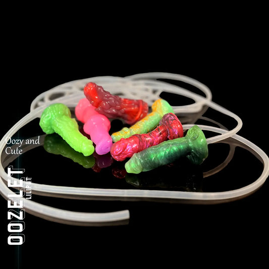 Oozelet Liliput collection of small fantasy-inspired toys in vibrant colours, with syringe and tubing set – compact, playful