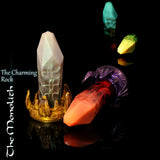 Monolith crystal fantasy dildo by Love Smiths with alien crown base, glowing rune-like veins and faceted crystal shaft in multiple colour variations.