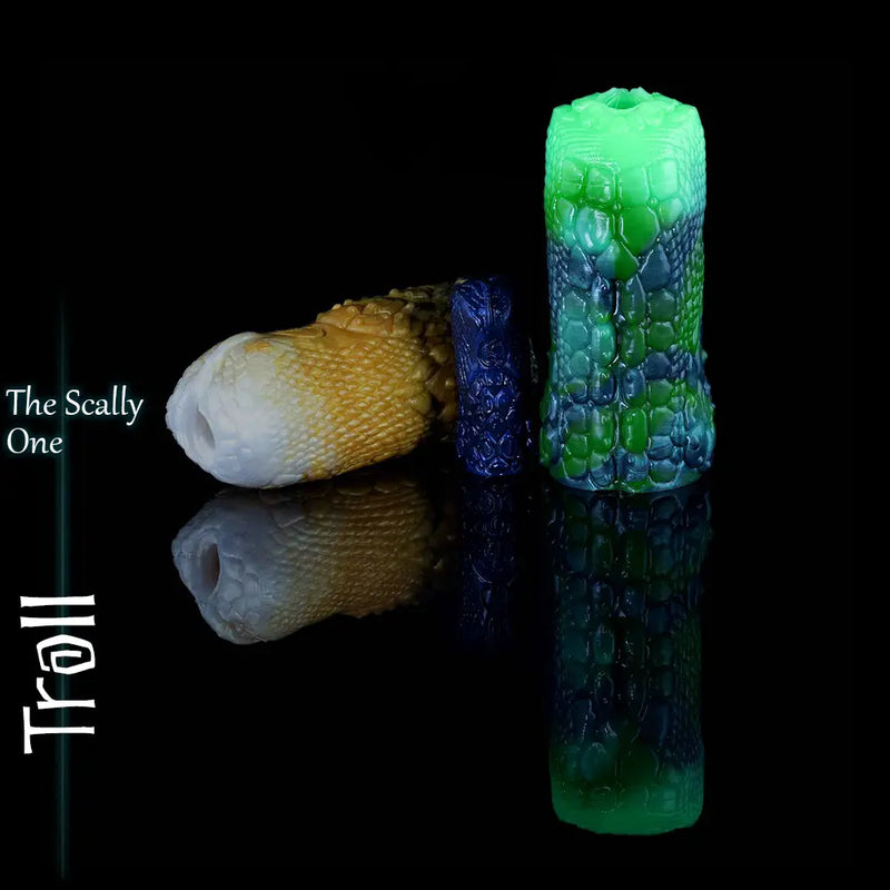 Three Troll fantasy silicone masturbators in gold-white, blue and green colourways, showing the scaled exterior from different angles