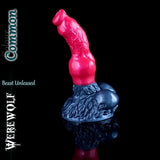 Fantasy silicone werewolf dildo in the Common colourway featuring a bright red shaft and dark metallic grey base and balls, displayed on a black reflective background.
