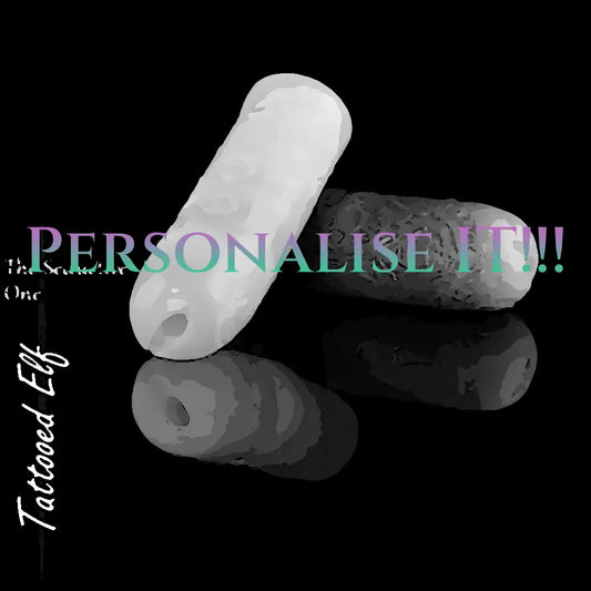 Personalised Tattooed Elf silicone masturbators in white and dark custom colours, showing the narrow entrance and engraved exterior