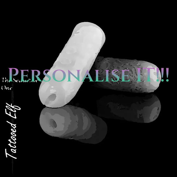 Personalised Tattooed Elf silicone masturbators in white and dark custom colours, showing the narrow entrance and engraved exterior