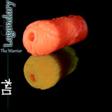 Legendary Ork masturbateur en silicone en vivid phosphorescent orange, avec un fantasy-armureed exterior et ouverture texturée