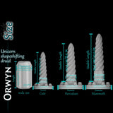 Size comparison of Orwyn Unicorn Shape-Shifting Druid dildo next to a 355ml soda can, showing usable length 17 cm (6.7 in), base diameter 11 cm (4.3 in), and shaft diameter 4.3 cm (1.7 in).